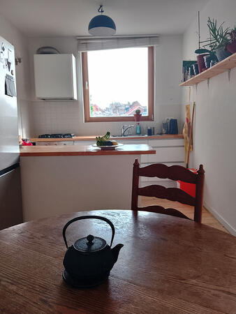 Kitchen view from the dining table, with natural light and a warm atmosphere